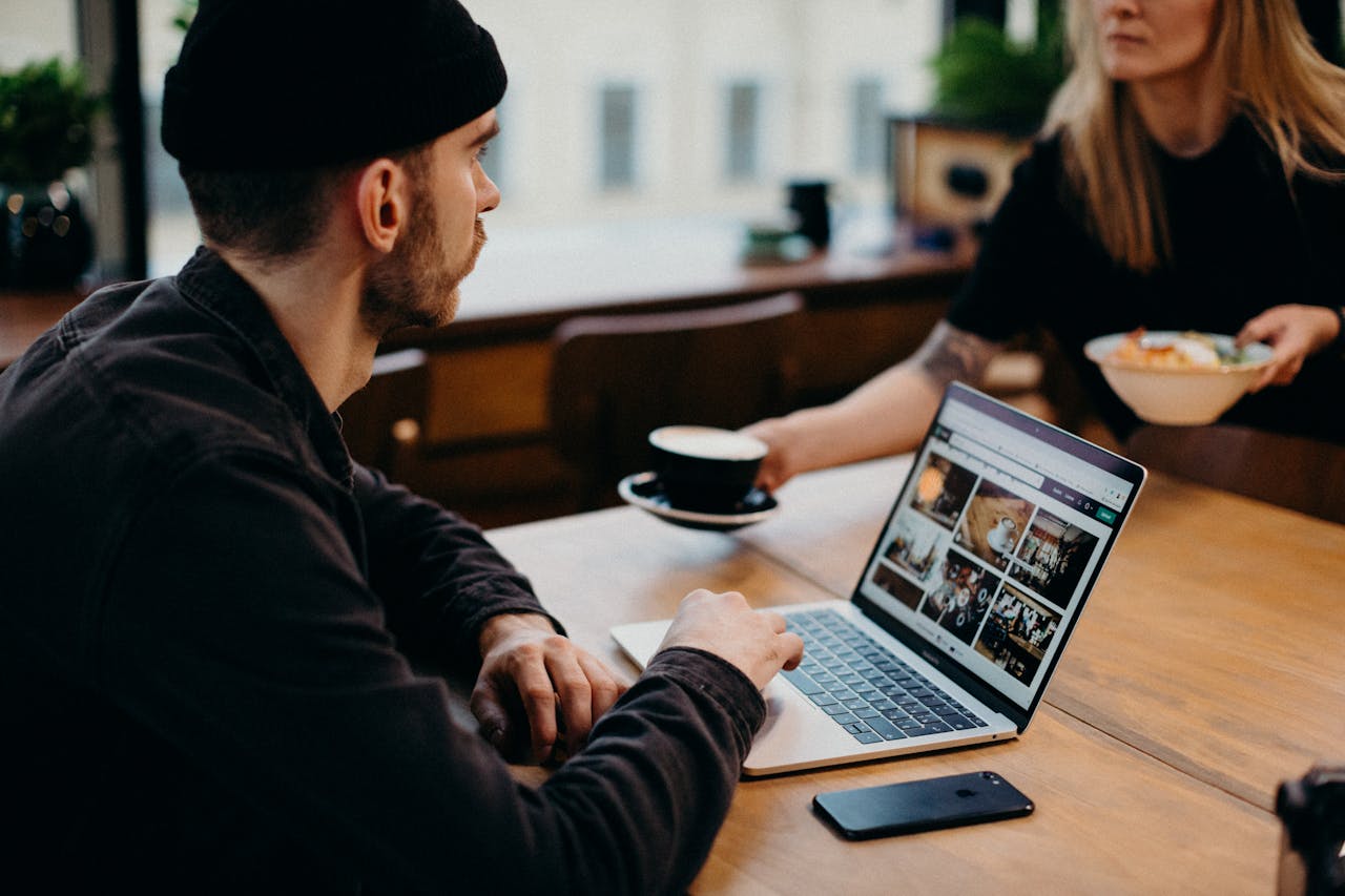 Freelancer working on a laptop in a cozy café setting. Ideal for remote work themes.